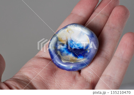 worry stone healing on gray background 135210470