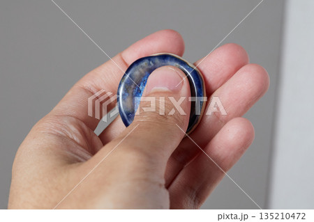 worry stone healing on gray background 135210472