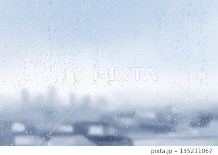 Rainy Day Window View with Blurred City Background 135211067