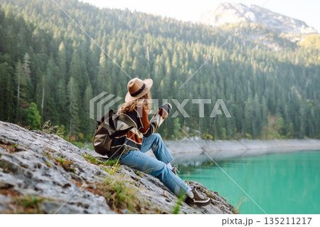 Adventure woman feeling happy among amazing mountains, forest and lake, enjoy the nature landscape Adventure woman feeling happy among amazing mountains, forest and lake, enjoy the nature landscape 135211217