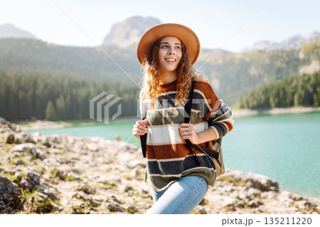 Adventure woman feeling happy among amazing mountains, forest and lake, enjoy the nature landscape Adventure woman feeling happy among amazing mountains, forest and lake, enjoy the nature landscape 135211220