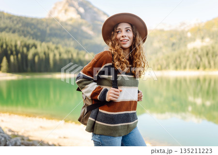 Adventure woman feeling happy among amazing mountains, forest and lake, enjoy the nature landscape Adventure woman feeling happy among amazing mountains, forest and lake, enjoy the nature landscape 135211223