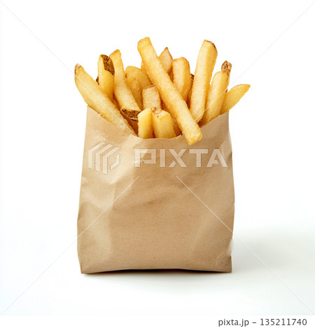 A brown paper bag filled with golden, crispy French fries is shown against a white background. A brown paper bag filled with golden, crispy French fries is shown against a white background. 135211740
