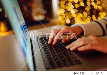 Close-up of hands working on a laptop keyboard. Freelance, online course. Shopping online. 135212146