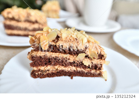 A slice of homemade almond cake on the table 135212324