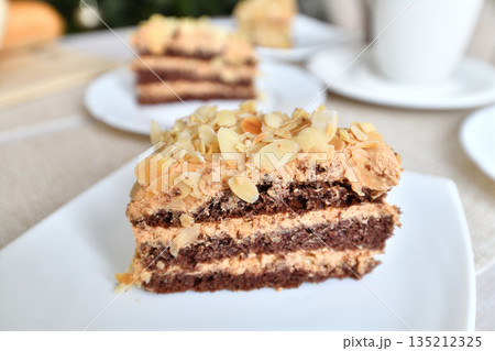 A slice of homemade almond cake on the table 135212325