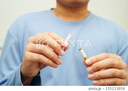 Quit smoking, Asian man breaking destroy cigarette in hand. 135213058