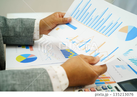 Asian business woman working with financial graph. 135213076