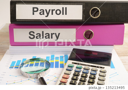 Salary Payroll. binder with graph and calculator in business office. 135213495