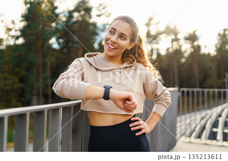 Young woman in sportswear is training outdoors. Sports concept, healthy body. 135213611