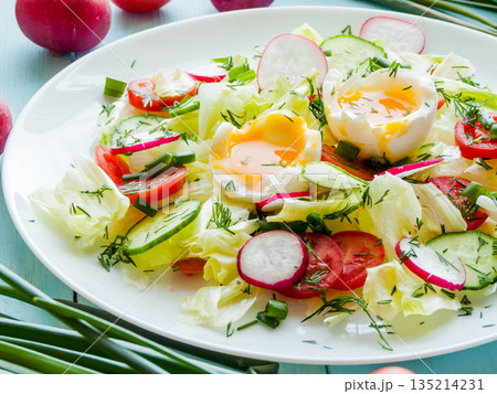 Plate with salad of radish, cherry tomatoes, cucumber, greens iceberg and boiled eggs in olive oil. Plate with salad of radish, cherry tomatoes, cucumber, greens iceberg and boiled eggs in olive oil. 135214231