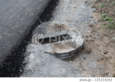 Construction of a concrete septic tank installation site in a residential area during daylight hours Construction of a concrete septic tank installation site in a residential area during daylight hours 135214292