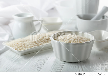 Raw organic rice in white dish. 135215267
