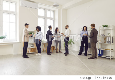 Business Team Communicating During Office Meeting, Presentation, or Event Business Team Communicating During Office Meeting, Presentation, or Event 135216450