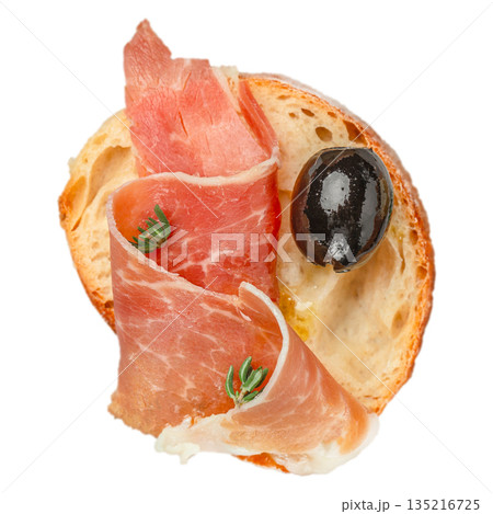 Bruschetta with prosciutto ham and black olive on toasted bread isolated on white background 135216725