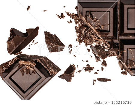 Broken dark chocolate bar with scattered pieces isolated on white background 135216739