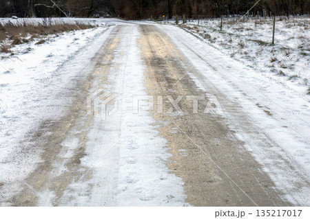 Slippery road covered in ice and snow. 135217017