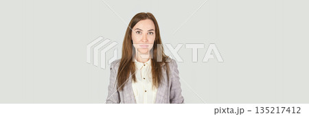 Young caucasian adult female in professional attire with neutral background 135217412