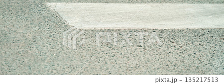 Crosswalk and pavement texture close-up in urban setting 135217513