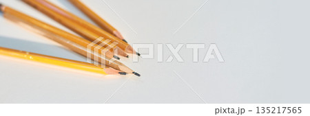 Close-up view of six yellow wooden pencils with erasers on white background Close-up view of six yellow wooden pencils with erasers on white background 135217565