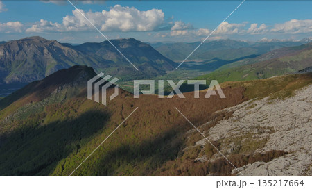 Rocky mountains and valley before sunset aerial Rocky mountains and valley before sunset aerial 135217664