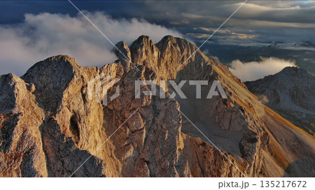 Amazing rocky mountains in clouds at sunset 135217672