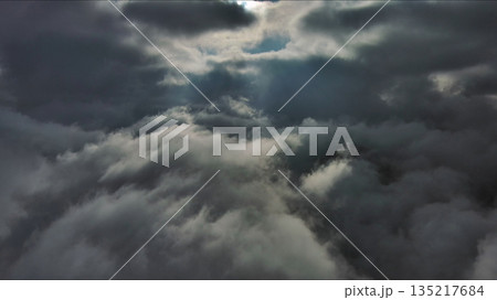 Aerial high view of dramatic clouds and sun 135217684