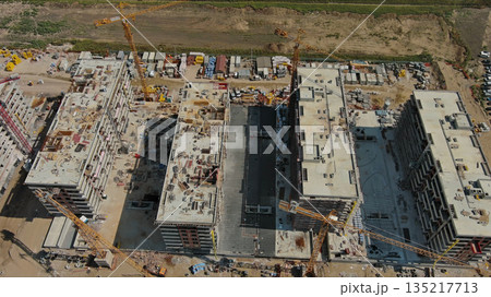Industrial construction site with houses equipment and materials 135217713