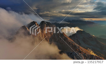 Amazing rocky mountains in clouds at sunset 135217917