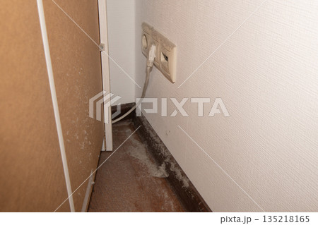 Dust bunnies accumulating behind furniture showing lack of cleaning Dust bunnies accumulating behind furniture showing lack of cleaning 135218165