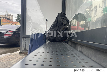 black backpack on the bus stop bench black backpack on the bus stop bench 135218252