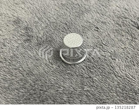 A thimble for taylor isolated on gray background A thimble for taylor isolated on gray background 135218287