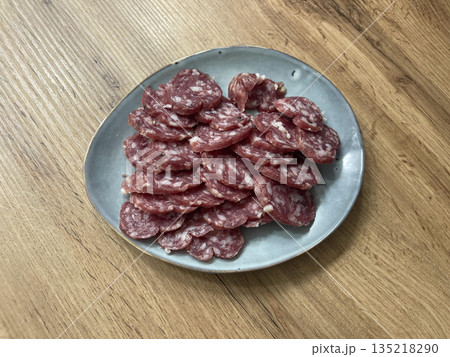 a plate of sliced sausages a plate of sliced sausages 135218290