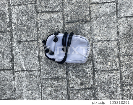 a handbag isolated on the sidewalk in the city a handbag isolated on the sidewalk in the city 135218291