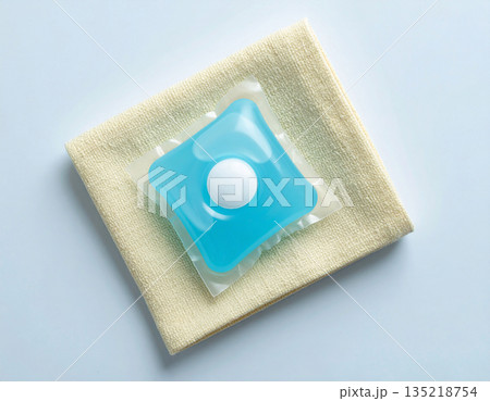 Brand friendly. Soluble laundry detergent capsule on a neutral linen cloth with empty space for text. 135218754