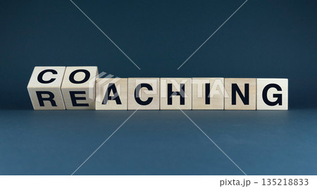A conceptual image of wooden blocks spelling out 'coaching' and 'reaching' A conceptual image of wooden blocks spelling out 'coaching' and 'reaching' 135218833