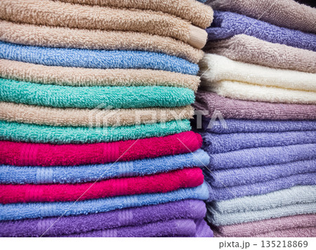 Colorful towels neatly stacked in a vibrant display at a local store 135218869