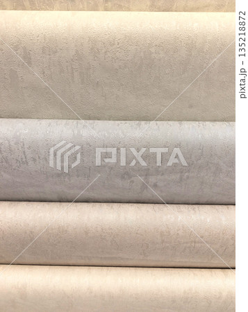 Textured rolls of fabric in soft neutral shades at the design studio 135218872