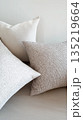 Neutral throw pillows with textured fabric in modern interior 135219664
