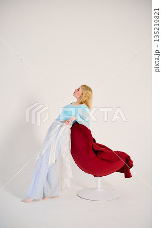 contemporary dancer balance white woman with red chair contemporary dancer balance white woman with red chair 135219821