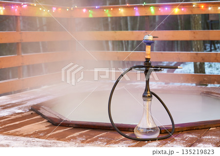 Serene snowy setting featuring lone hookah and soft illumination Serene snowy setting featuring lone hookah and soft illumination 135219823
