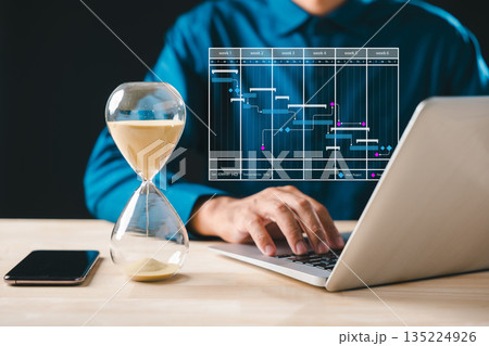 Hourglass time glass hour sand clock concept urgency timer emphasizes business growth deadline countdown, person works on laptop optimizing project schedule for future company success development Hourglass time glass hour sand clock concept urgency timer emphasizes business growth deadline countdown, person works on laptop optimizing project schedule for future company success development 135224926