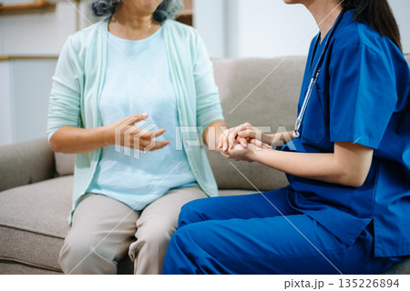 Asian nurse providing home healthcare to elderly woman. Professional caregiver offering senior care, medical consultation, compassion Asian nurse providing home healthcare to elderly woman. Professional caregiver offering senior care, medical consultation, compassion 135226894