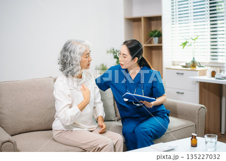 Young Asian woman, nurse, caregiver, carer of nursing home talking with senior Asian woman feeling happy Young Asian woman, nurse, caregiver, carer of nursing home talking with senior Asian woman feeling happy 135227032
