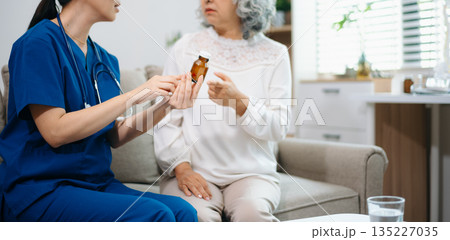 Young Asian woman, nurse, caregiver, carer of nursing home talking with senior Asian woman feeling happy Young Asian woman, nurse, caregiver, carer of nursing home talking with senior Asian woman feeling happy 135227035