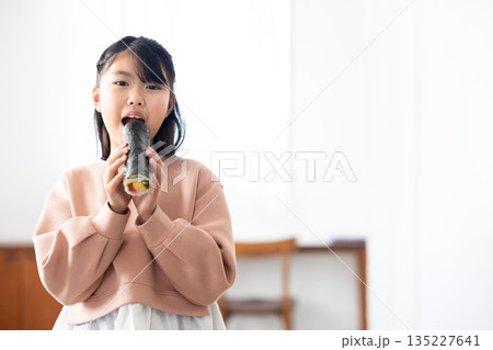 恵方巻きを丸かぶりする女の子 135227641