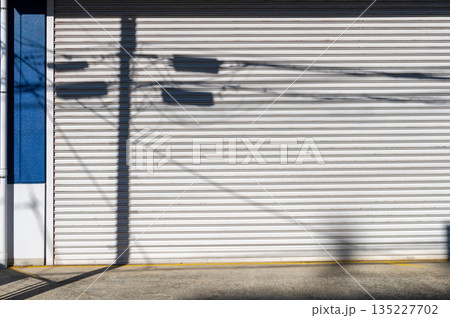 A closeup shot of automatic metal roller door used in factory, storage, garage, and industrial warehouse. The corrugated and foldable metal sheet offer space saving and provide urban and rustic feel 135227702
