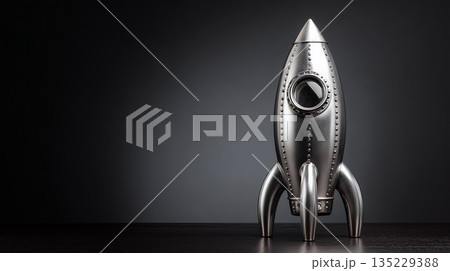 メタリックなロケット模型と黒背景の近未来イメージ｜スタートアップやテクノロジー表現に最適 135229388