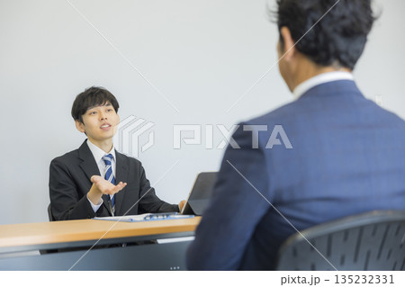 笑顔で話を聞くビジネスマン 　 135232331