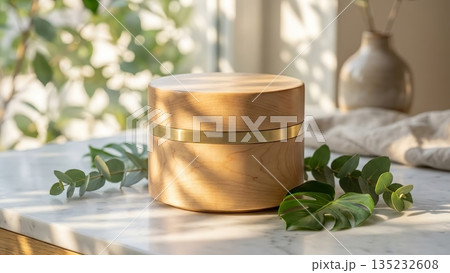 Wooden cosmetic jar mockup on marble table with green leaves. 135232608